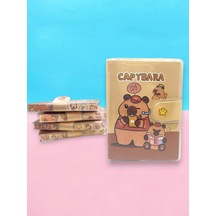 Capybara A7 Not Defteri , Çıt Çıtlı Cep Defteri - Kitap Okuyan Capybara Sarı