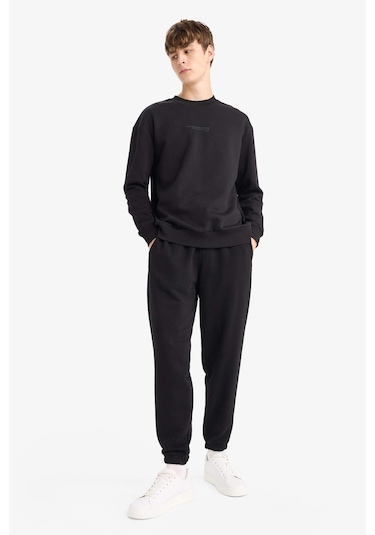 Defacto - Regular Fit Beli Bağcılı Paçası Lastikli Cepli Basic Düz Jogger Eşofman Altı E9427AX25AU Siyah Defacto - Regular Fit Beli Bağcılı Paçası Lastikli Cepli Basic Düz Jogger Eşofman Altı E9427AX25AU Siyah