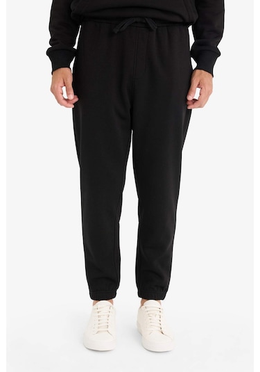 Defacto - Regular Fit Beli Bağcıklı Cepli Paçası Lastikli Şardonlu Basic Düz Jogger Eşofman Altı E6326AX25AU Siyah Defacto - Regular Fit Beli Bağcıklı Cepli Paçası Lastikli Şardonlu Basic Düz Jogger Eşofman Altı E6326AX25AU Siyah