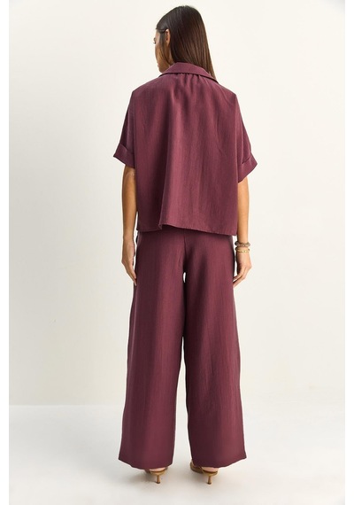 Shade Kadın Oversize Kısa Kol Gömlek Beli Lastikli Geniş Paça Pantolon Takım 7651 60286138 - Mürdüm Shade Kadın Oversize Kısa Kol Gömlek Beli Lastikli Geniş Paça Pantolon Takım 7651 60286138 - Mürdüm