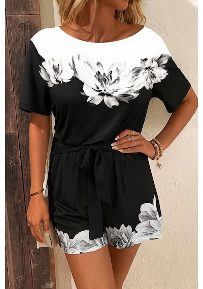 Kadın Tek Omuzu Açık Çiçek Desenli Beli Kuşaklı Iki Iplik Mini Short Tulum Siyah