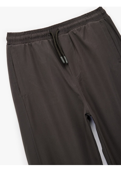 Koton Cepli Beli Lastikli Bağlamalı Loose Fit Jogger Paraşüt Pantolon Antrasit 6wkb40018tw Antrasit