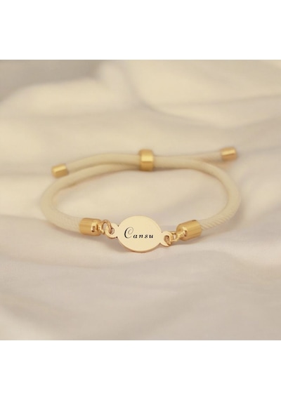 Archin Cansu İsmine Özel Beyaz Örgü İpli 14 Ayar Altın Plakalı Oval Motifli Hediye Bileklik-424isim Cansu Archin Cansu İsmine Özel Beyaz Örgü İpli 14 Ayar Altın Plakalı Oval Motifli Hediye Bileklik-424isim Cansu